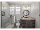 Modern bathroom with a glass-enclosed shower, designer mirror, and vanity with neutral quartz countertop at 9441 N 129Th Pl, Scottsdale, AZ 85259