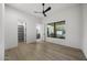 Bright bedroom with hardwood floors, a walk-in closet, and a view from the large picture window at 9441 N 129Th Pl, Scottsdale, AZ 85259