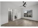 Bright bedroom with hardwood floors, a walk-in closet, and an en-suite bathroom at 9441 N 129Th Pl, Scottsdale, AZ 85259