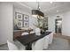 Elegant dining room with modern lighting, designer furnishings, and a view of the adjacent spaces at 9441 N 129Th Pl, Scottsdale, AZ 85259