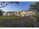 Beautiful home exterior featuring a modern facade, manicured landscaping, and stone front yard at 9441 N 129Th Pl, Scottsdale, AZ 85259