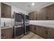Well-equipped laundry room featuring modern washer/dryer units and ample cabinet space at 9441 N 129Th Pl, Scottsdale, AZ 85259