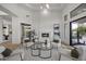 Bright living room with a fireplace, modern furnishings, and a wine display at 9441 N 129Th Pl, Scottsdale, AZ 85259