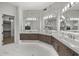Elegant bathroom with double vanities, marble counters, tile floors, and modern lighting at 9441 N 129Th Pl, Scottsdale, AZ 85259
