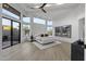 Bright main bedroom with high ceilings, picture windows, ceiling fan and access to the outdoors at 9441 N 129Th Pl, Scottsdale, AZ 85259