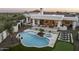 Resort-style backyard boasts a pristine pool, spa, putting green and outdoor entertaining areas at 9441 N 129Th Pl, Scottsdale, AZ 85259