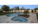Beautiful backyard with a sparkling pool, lush landscaping, and a tranquil waterfall feature at 9441 N 129Th Pl, Scottsdale, AZ 85259
