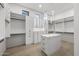 Spacious walk-in closet with custom shelving, drawers, and modern lighting at 9441 N 129Th Pl, Scottsdale, AZ 85259