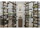 Custom wine room featuring stylish racking and display, with an adjacent seating area at 9441 N 129Th Pl, Scottsdale, AZ 85259
