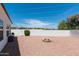 Spacious backyard featuring desert landscaping, a fire pit, and a wall with mountain views in the distance at 9791 N 118Th Way, Scottsdale, AZ 85259
