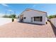 Backyard featuring a gravel area, a patio, white walls, and a view of the roofline at 9791 N 118Th Way, Scottsdale, AZ 85259