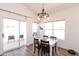 Bright dining area with a modern chandelier, sliding glass doors, and outdoor views at 9791 N 118Th Way, Scottsdale, AZ 85259