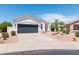 Desert home with a gray garage door, desert landscaping and a tile roof at 9791 N 118Th Way, Scottsdale, AZ 85259