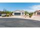 Charming home featuring desert landscaping, a gray garage door and a tile roof at 9791 N 118Th Way, Scottsdale, AZ 85259