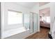 Main bathroom with tub, glass shower, and lots of bright natural light at 9791 N 118Th Way, Scottsdale, AZ 85259