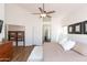 Cozy main bedroom with ceiling fan, ensuite, and a decorative privacy screen at 9791 N 118Th Way, Scottsdale, AZ 85259