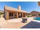 Backyard patio offers ample space for outdoor entertaining near pool, outdoor kitchen and fire pit at 10931 N 129Th Way, Scottsdale, AZ 85259