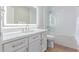 Modern bathroom with white cabinets, quartz countertop, and illuminated mirror above the sink at 10931 N 129Th Way, Scottsdale, AZ 85259