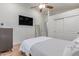 Bedroom features a ceiling fan, wood floors, a closet, and a mounted TV at 10931 N 129Th Way, Scottsdale, AZ 85259