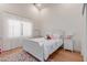 Bright bedroom featuring hardwood floors, white trim, and large window with sheer curtains at 10931 N 129Th Way, Scottsdale, AZ 85259