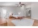 Bright bedroom features a ceiling fan, wood floors, and access to the ensuite bathroom at 10931 N 129Th Way, Scottsdale, AZ 85259
