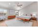 Primary bedroom featuring hardwood floors, large windows and a large bed with a ceiling fan at 10931 N 129Th Way, Scottsdale, AZ 85259