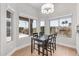 Bright breakfast nook featuring wood floors, black table, and large windows with outdoor views at 10931 N 129Th Way, Scottsdale, AZ 85259