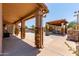 Enjoy outdoor living with a spacious covered patio with a stone column and an outdoor kitchen at 10931 N 129Th Way, Scottsdale, AZ 85259