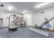 Spacious home gym with a variety of exercise equipment and rubber flooring at 10931 N 129Th Way, Scottsdale, AZ 85259