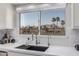 A kitchen sink with a window looking out to palm trees and other homes at 10931 N 129Th Way, Scottsdale, AZ 85259