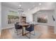 Open-concept living and dining area with hardwood floors, neutral walls, comfortable seating, and ample natural light at 10931 N 129Th Way, Scottsdale, AZ 85259