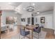 Open-concept living and dining area featuring hardwood floors, comfortable seating, and a chandelier at 10931 N 129Th Way, Scottsdale, AZ 85259