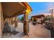 Covered patio with stone columns, adjacent to an outdoor kitchen, bar and poolside cabana at 10931 N 129Th Way, Scottsdale, AZ 85259