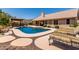Backyard features refreshing pool, covered patio, rock and paver landscaping, and lounge chairs at 10931 N 129Th Way, Scottsdale, AZ 85259