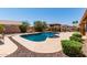 Inviting backyard pool features a built in spa, rock landscaping, and covered outdoor kitchen area at 10931 N 129Th Way, Scottsdale, AZ 85259