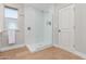 Glass enclosed shower with rain shower head, white tile, and hardwood floors at 10931 N 129Th Way, Scottsdale, AZ 85259