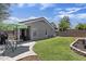 Spacious backyard with grass, patio, and brick wall offering privacy at 11330 W Eden Mckenzie Dr, Surprise, AZ 85378