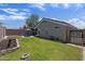 Landscaped backyard with lush green grass, stone accents, and a covered patio at 11330 W Eden Mckenzie Dr, Surprise, AZ 85378