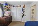 Bright bedroom featuring closet, playful decor, dresser with TV, and doorway to another room at 11330 W Eden Mckenzie Dr, Surprise, AZ 85378