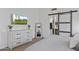 Bedroom featuring a dresser, mirror, TV, and a sliding barn door to the bathroom at 11330 W Eden Mckenzie Dr, Surprise, AZ 85378