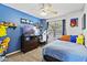 Charming bedroom with a themed decor, cozy bedding and a ceiling fan at 11330 W Eden Mckenzie Dr, Surprise, AZ 85378