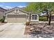 Charming single-story home with a two-car garage and desert landscaping at 11330 W Eden Mckenzie Dr, Surprise, AZ 85378