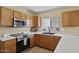Functional kitchen with stainless steel appliances and ample counter space at 11330 W Eden Mckenzie Dr, Surprise, AZ 85378