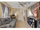 Versatile living space offering comfortable seating, neutral tones and a ceiling fan at 11330 W Eden Mckenzie Dr, Surprise, AZ 85378