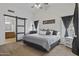 Vaulted ceiling main bedroom with barn door to bathroom, neutral tones, and large windows at 11330 W Eden Mckenzie Dr, Surprise, AZ 85378