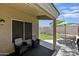Covered patio with outdoor seating and a view of the landscaped backyard at 11330 W Eden Mckenzie Dr, Surprise, AZ 85378
