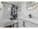 Bathroom featuring modern sink vanity, tile shower with curtain, and modern mirror at 1174 E Belmont Ave, Phoenix, AZ 85020