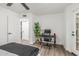 This bedroom features a ceiling fan, wood floors, and a functional desk/office space at 1174 E Belmont Ave, Phoenix, AZ 85020
