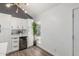 Modern kitchen with white cabinets, a wine fridge, quartz countertops, and gray walls with a large plant at 1174 E Belmont Ave, Phoenix, AZ 85020