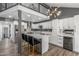 Modern kitchen with white cabinets, gray walls, quartz countertops, island with seating, and stainless steel appliances at 1174 E Belmont Ave, Phoenix, AZ 85020